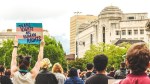 A crowd of people holding a sign that says "Transgender Rights are Human Rights"